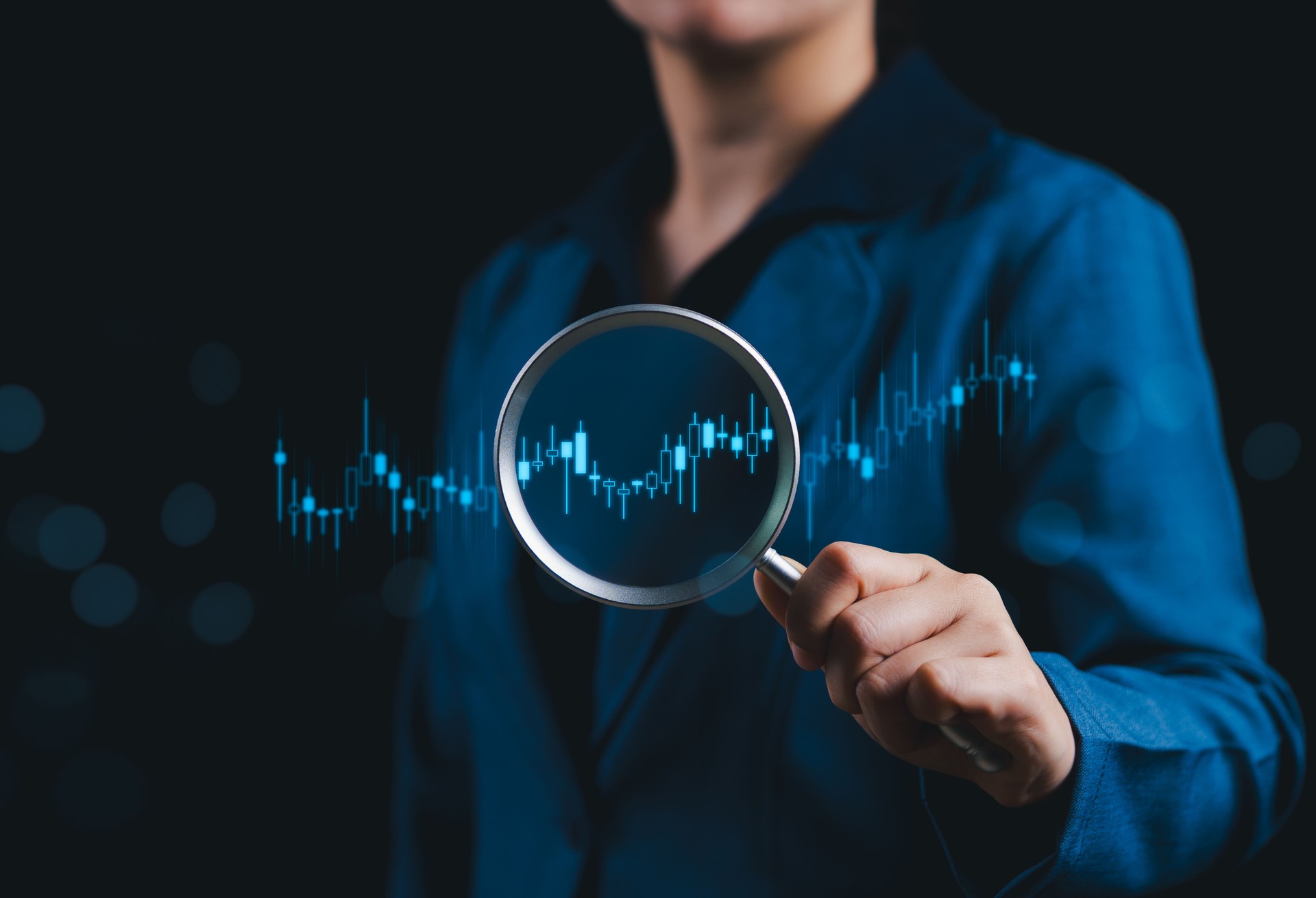 Data Analysis and Financial Market Research Concept. Businesswoman holding magnifying glass focusing candlestick chart, data analysis, investment research, market trends, and performance evaluation.